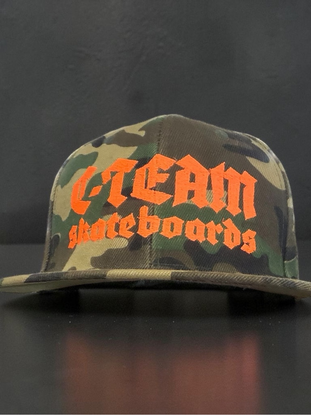 Camo Skateboard Logo Snapback Hat in Orange